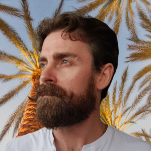 photo of Donovan, Co-founder at deacon solutions australia with a tropical back drop of palm trees